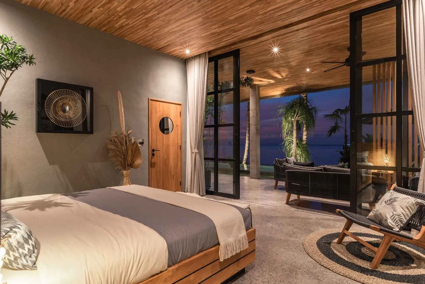 A suite opening to the terrace lounge at nightfall