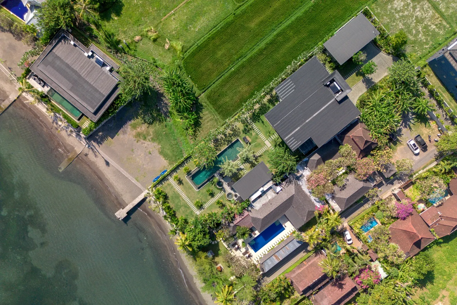 The shoreline from above, the pool house between rice fields and beach