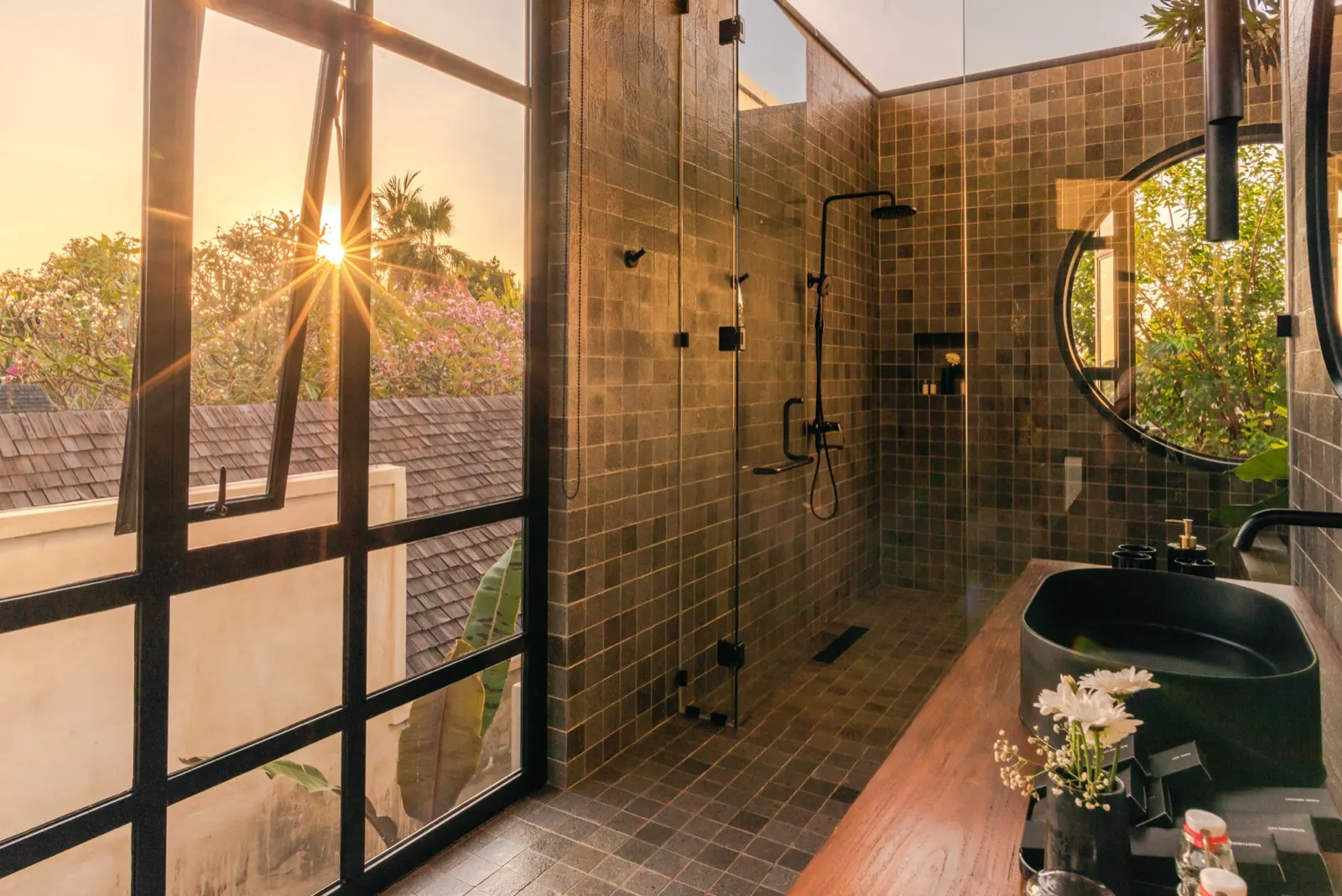 The shower at sunset, windows open to the trees
